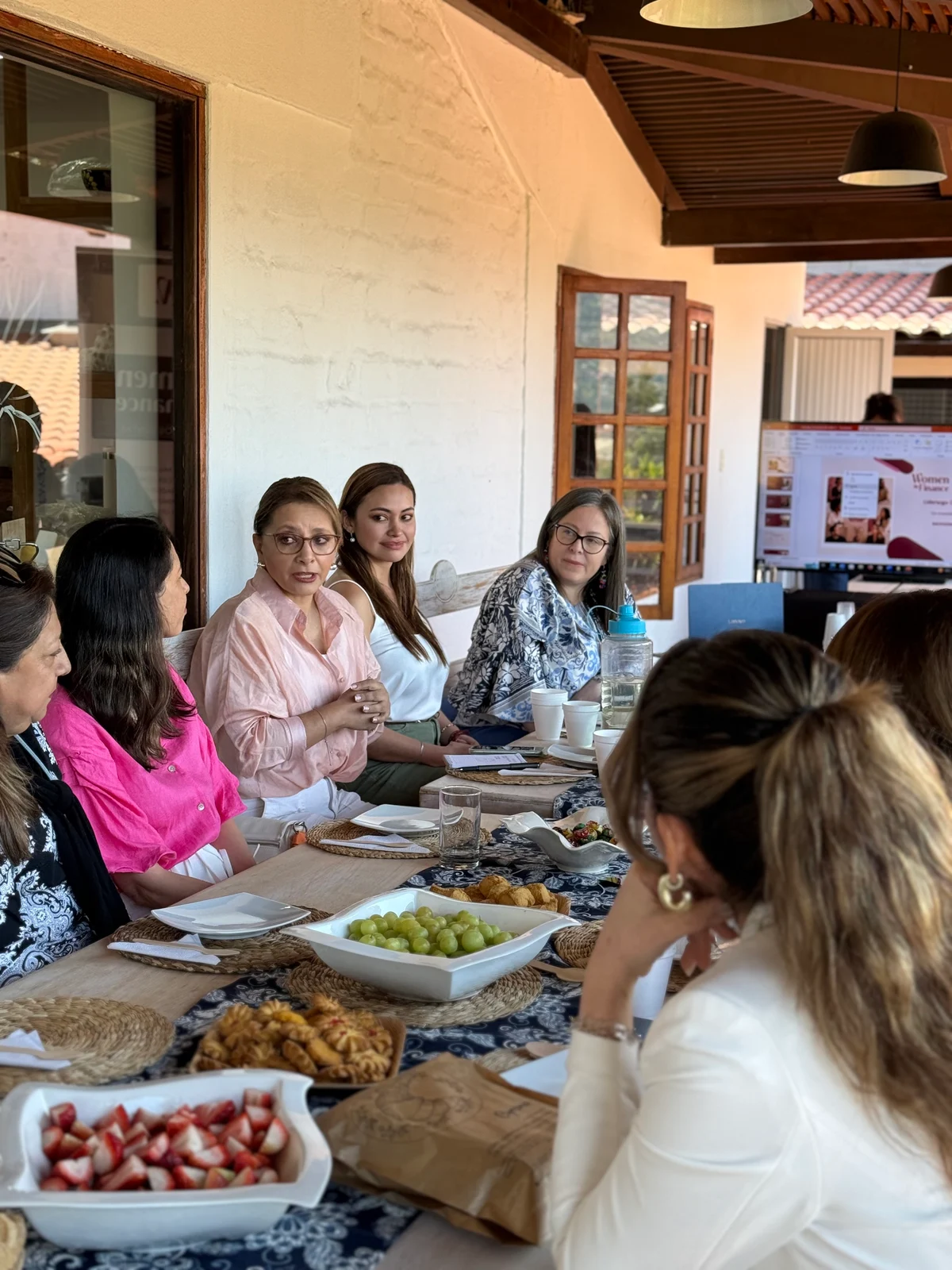 Participantes conversando alrededor de una mesa durante un encuentro WIF.